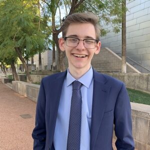 Smiling Nathaniel Ross wearing a blue suit.